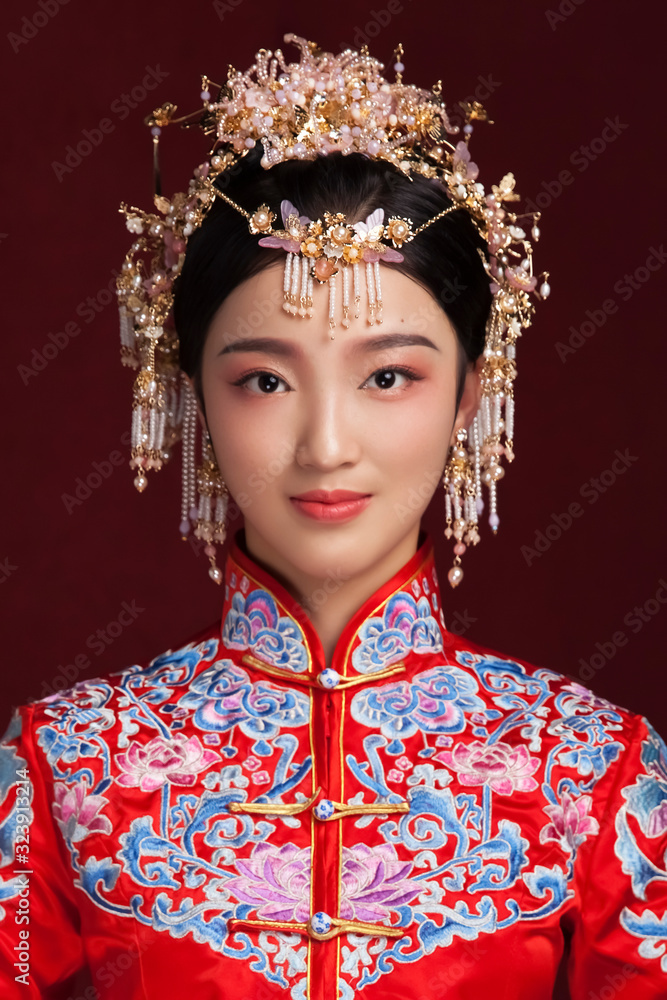Asian bride in costume styling in dark red background Asian bride in costume styling in dark red background