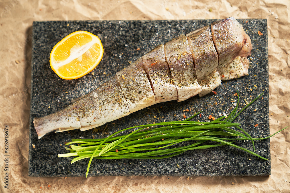 fish lemon and green onions on black Board cooking fish lemon and green onions on black Board cooking