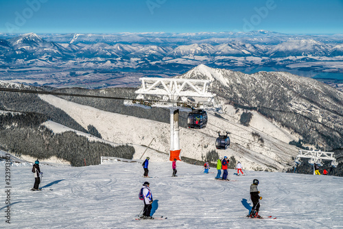 Skiers on slope at ski resort Jasna in Low Tatras mountains at SLovakia photo