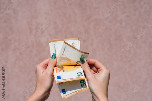 Hand couting holding and showing euro money or giving money. World money concept, 50 EURO banknotes EUR currency isolated with copy space. Concept of rich business people, saving or spending money. photo