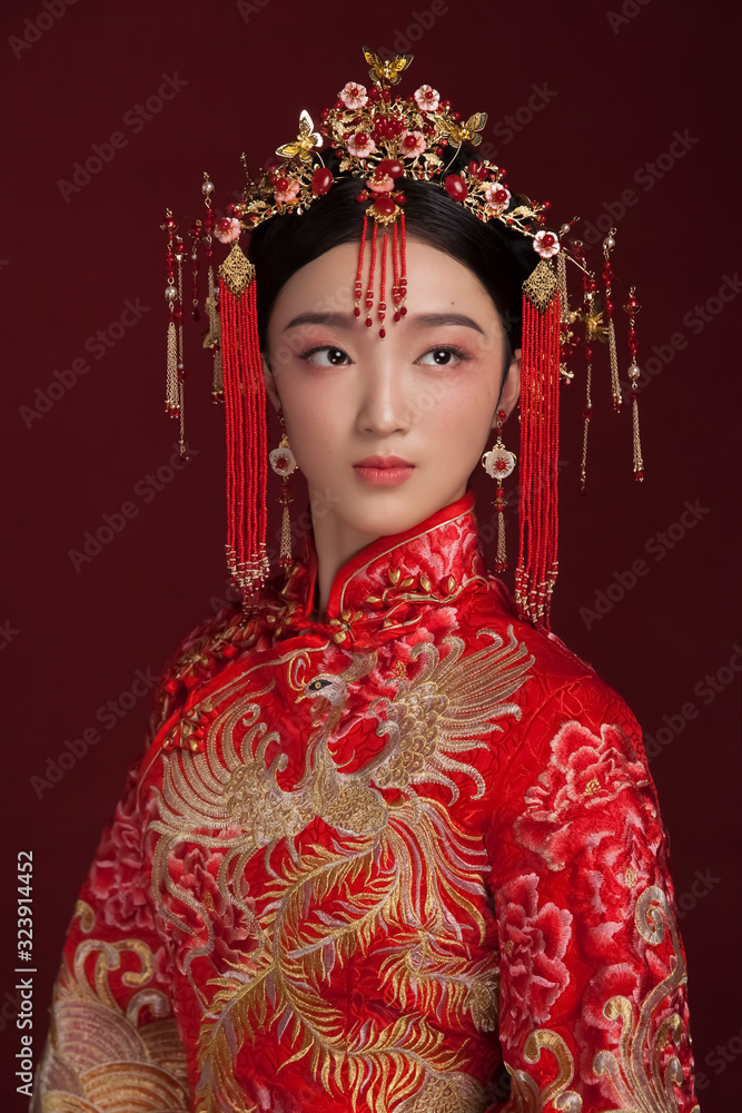 Asian bride in costume styling in dark red background Asian bride in costume styling in dark red background