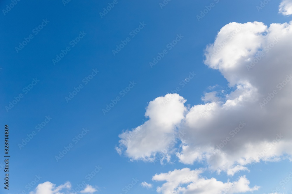 Scenic sky. Beautiful white soft fluffy clouds on a blue sky background