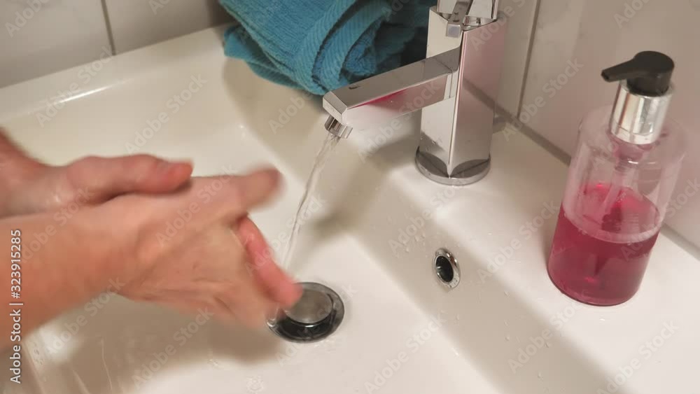 Close up of male person washing hands with soap on a sink in bathroom,protection Close up of male person washing hands with soap on a sink in bathroom,protection
