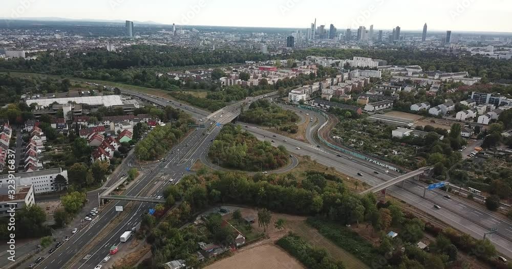 Aerial view of city landscape with autobahn motorway in metropolis, Bird's eye. Automobiles moving at street with modern automotive expressway. interchange road highway, junctions freeway Aerial view of city landscape with autobahn motorway in metropolis, Bird's eye. Automobiles moving at street with modern automotive expressway. interchange road highway, junctions freeway