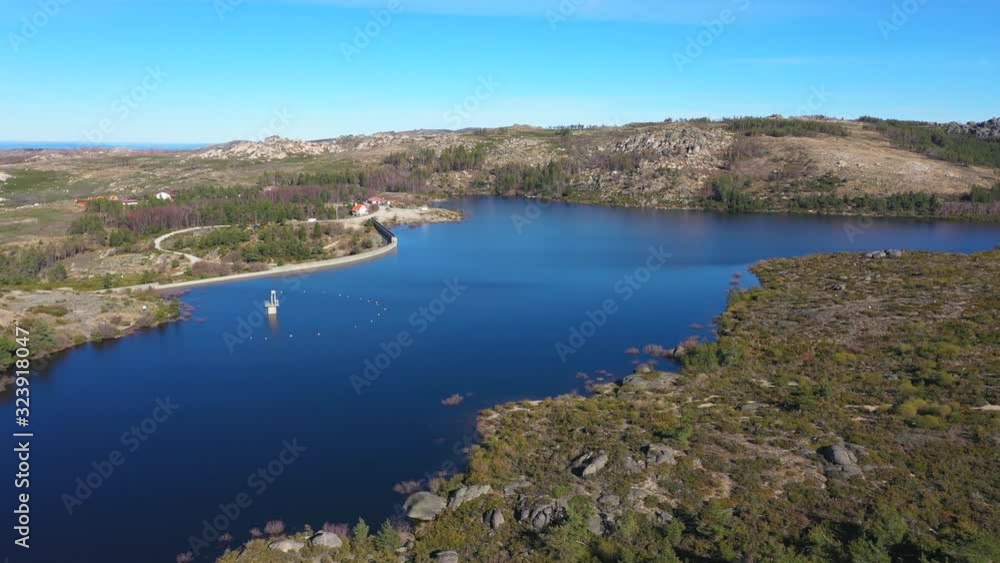 Aerial, drone shot, panning over lake Vale do Rossim, on a sunny day, in Serra da Estrela natural park, in Guarda, Portugal Aerial, drone shot, panning over lake Vale do Rossim, on a sunny day, in Serra da Estrela natural park, in Guarda, Portugal