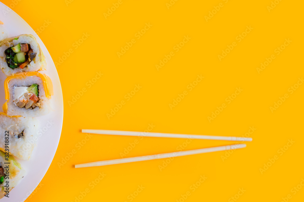 vegetarian sushi rolls on a white plate on a yellow vegetarian sushi rolls on a white plate on a yellow