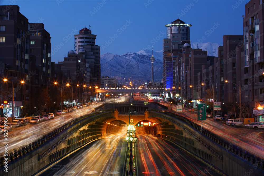 An Expressway and Underground tunnel in Tehran and a long exposure View of of mountains at the front just after the sunrise.