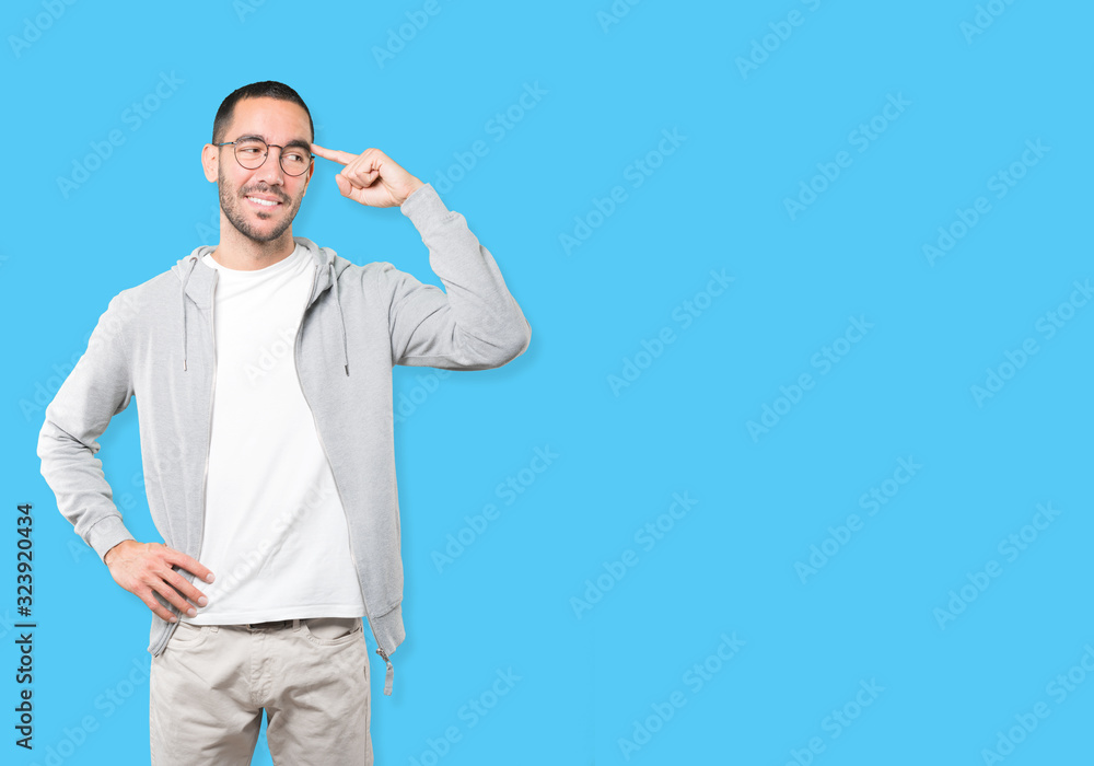 Happy young man doing a gesture of concentration Happy young man doing a gesture of concentration