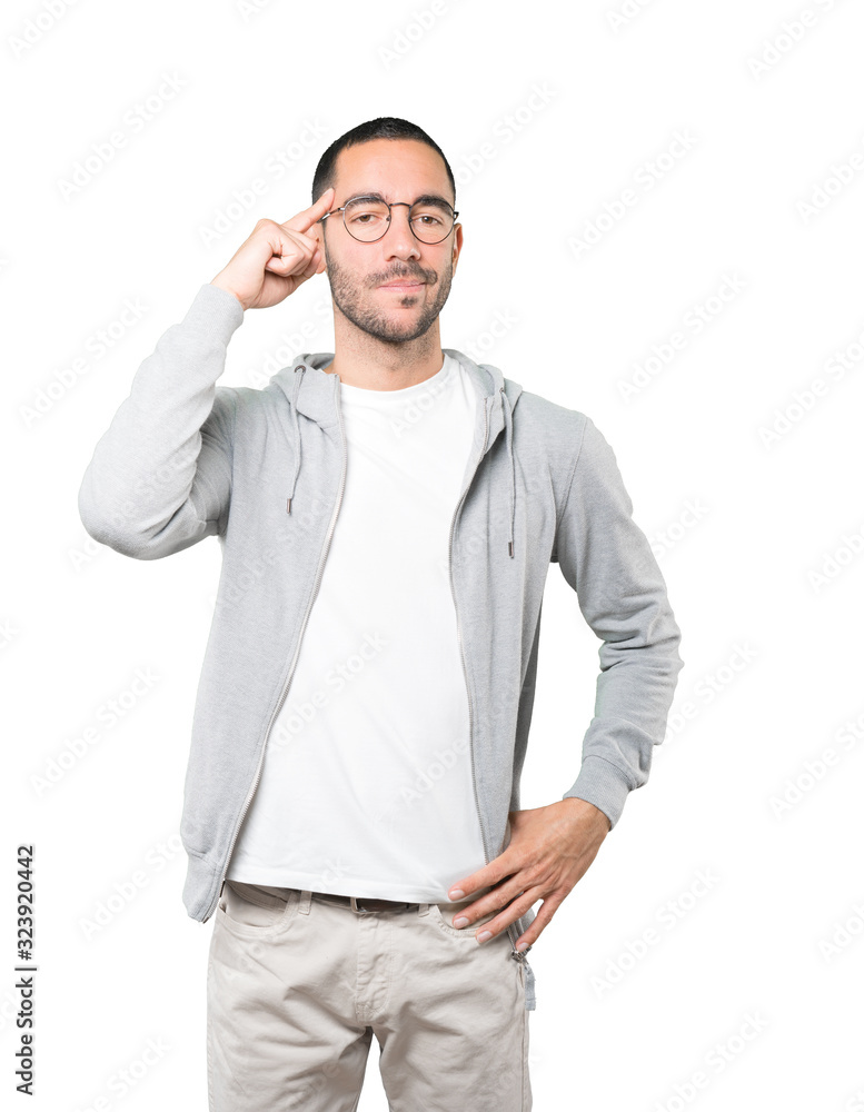 Serious young man doing a gesture of concentration Serious young man doing a gesture of concentration