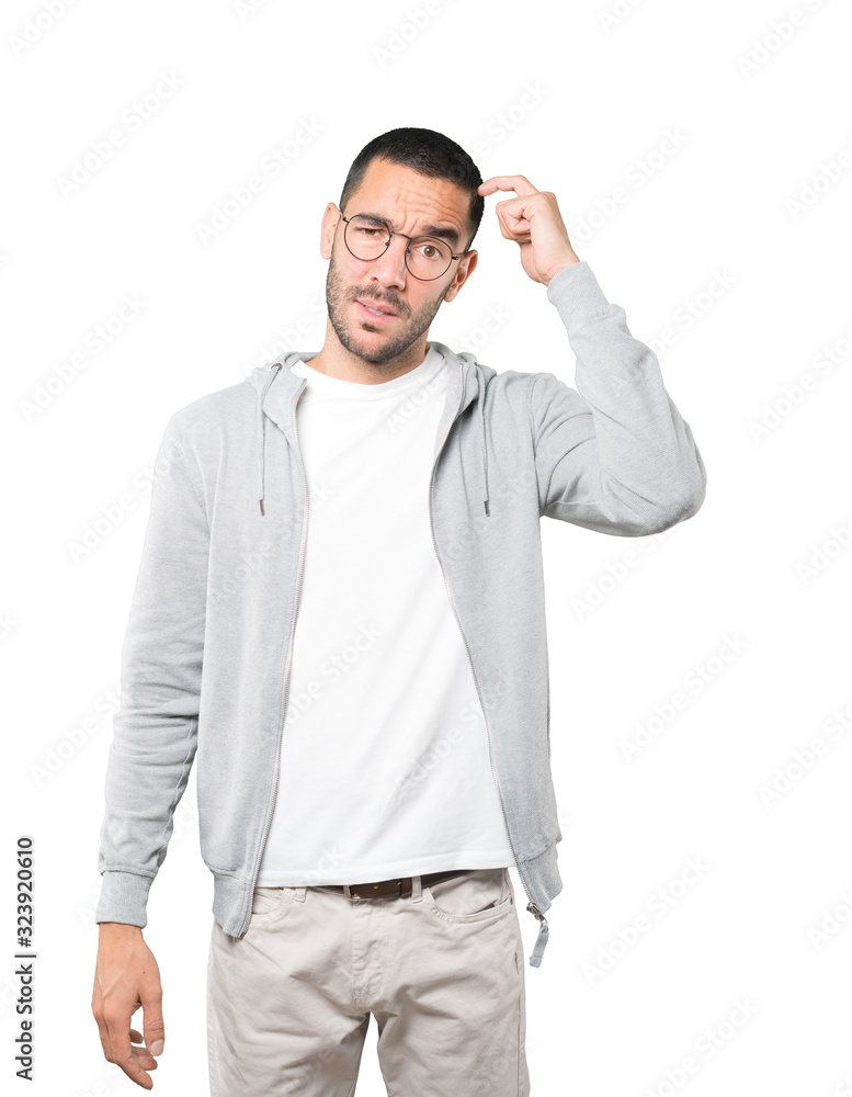 Concerned young man doing a gesture of confusion Concerned young man doing a gesture of confusion