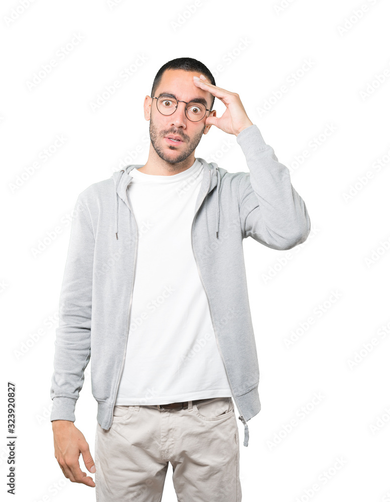 Depressed young man posing against background Depressed young man posing against background