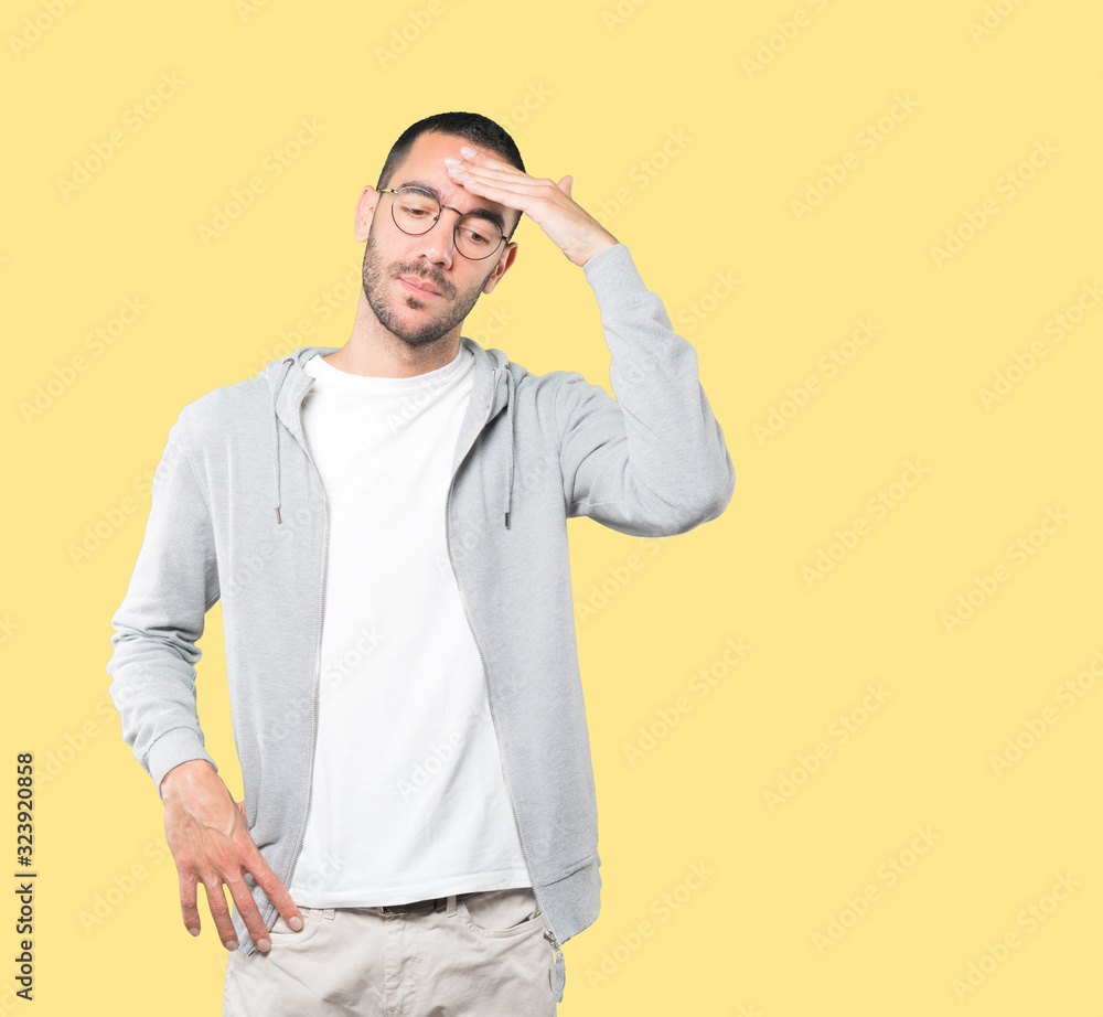 Depressed young man posing against background Depressed young man posing against background