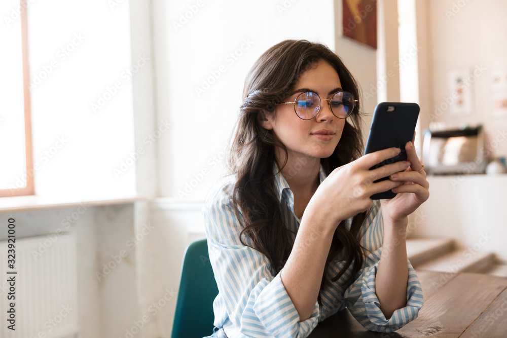 Lovely young brunette woman sitting at the cafe table Lovely young brunette woman sitting at the cafe table