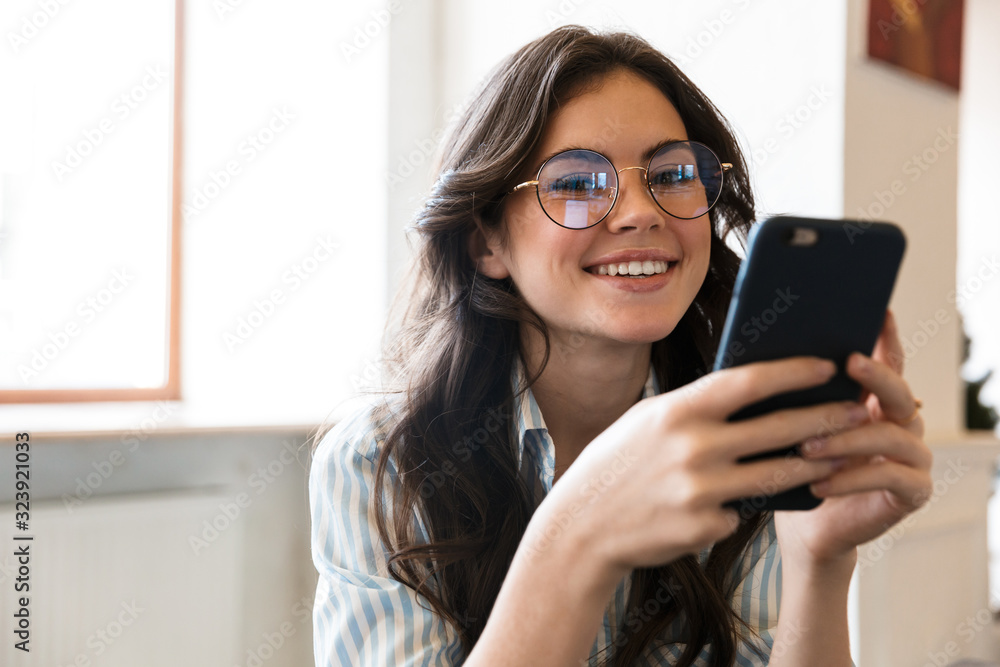 Lovely young brunette woman sitting at the cafe table Lovely young brunette woman sitting at the cafe table