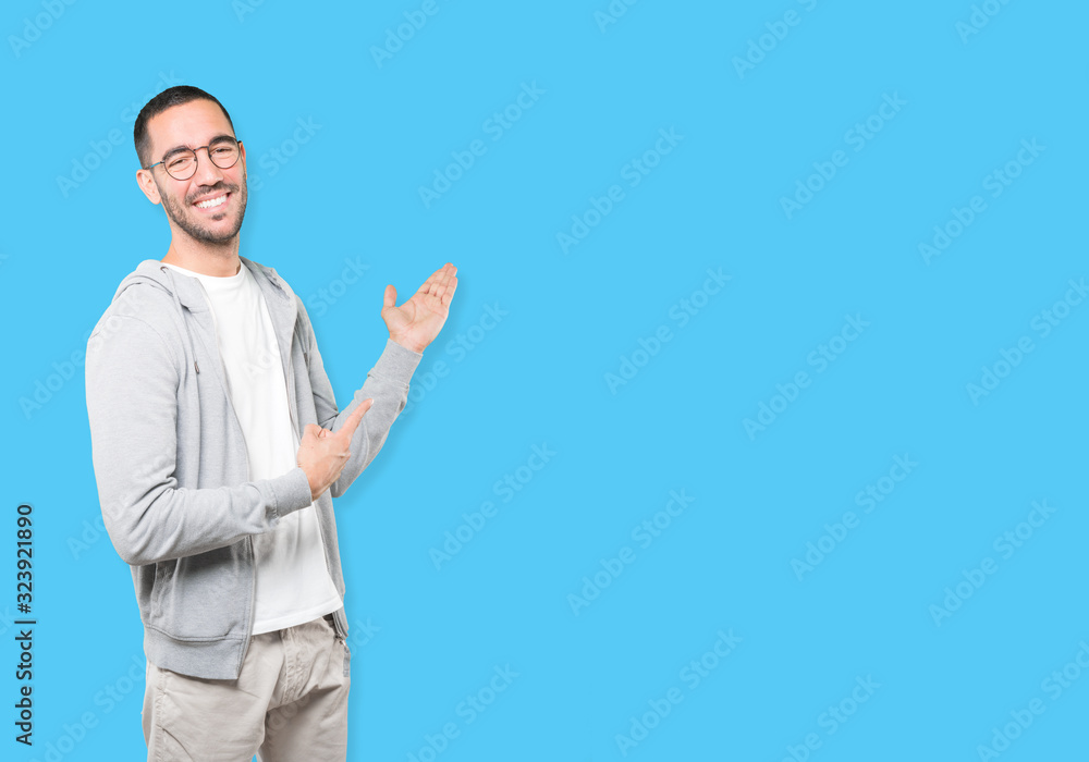 Amazed young man making a gesture of welcome Amazed young man making a gesture of welcome
