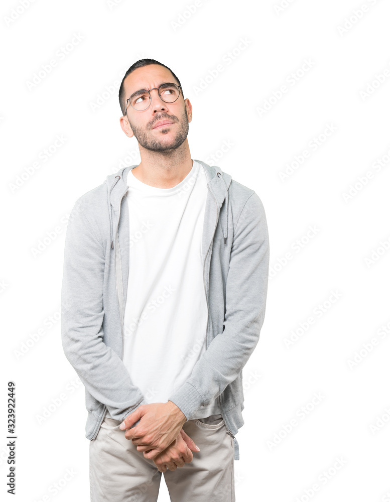 Serious young man looking against background Serious young man looking against background