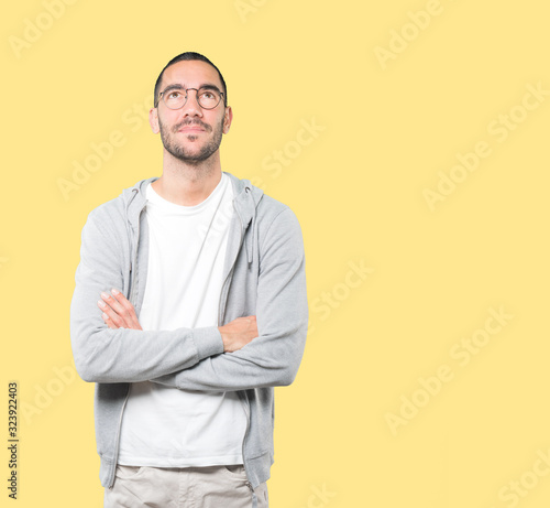 Happy young man looking against background