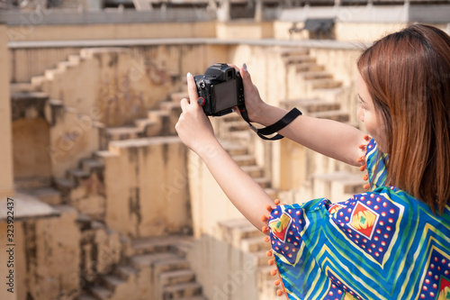 Portrait of young woman in Panna Meena ka Kund step-well at Jaipur in Rajasthan state, India photo