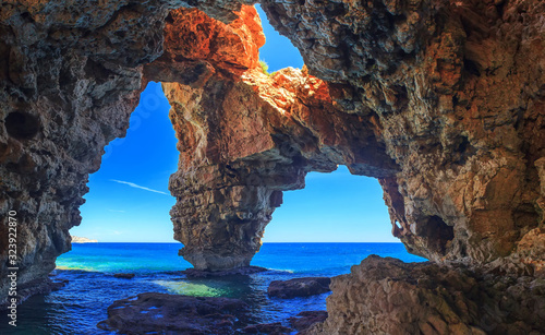 Caves by the sea in a beautiful place, rocks in the sea photo