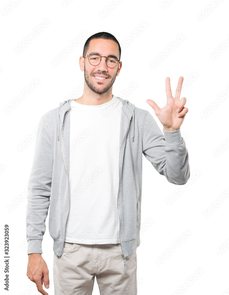 Young man making a number three gesture Young man making a number three gesture