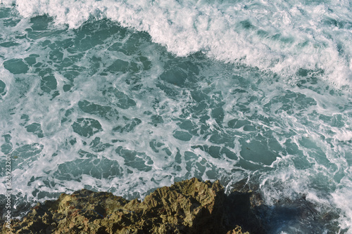 ocean waves crash against rocks