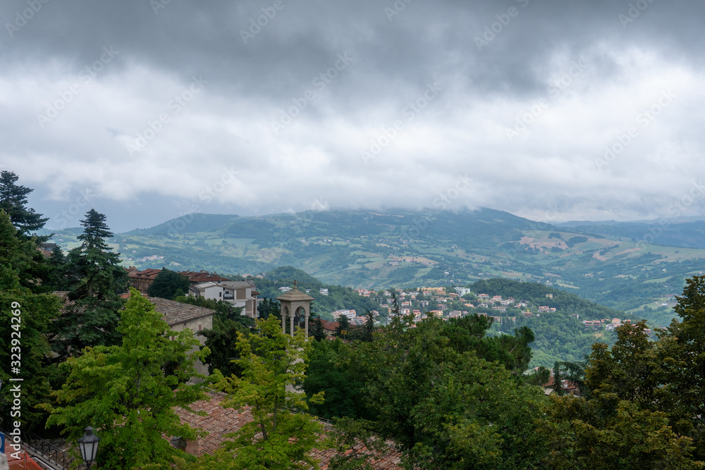 Old Ceramic Tile, roof. View of the surroundings of the Republic of San Marino. Chimneys and stormwater, lightning rods. mountains and fields in the background. Italy