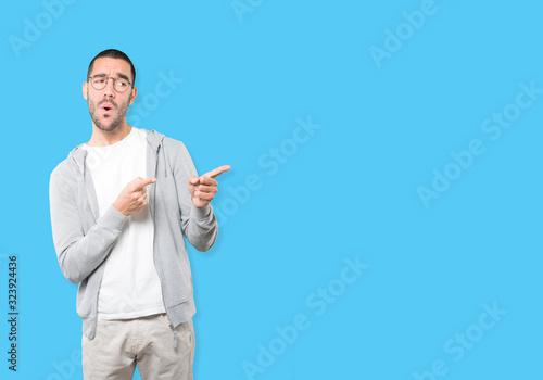 Amazed young man pointing at you with his finger
