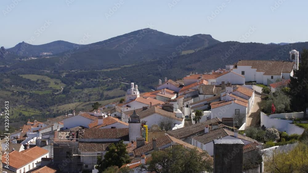 View of Marvao village with beautiful houses and church with rocky landscape mountains behind View of Marvao village with beautiful houses and church with rocky landscape mountains behind