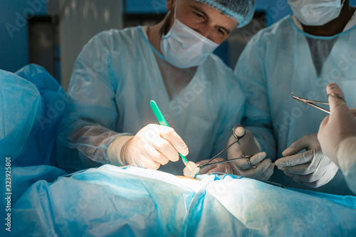 Close-ups of doctor's hands in medical gloves during surgery