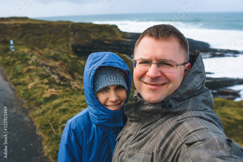couple making selfie in fron of seascape