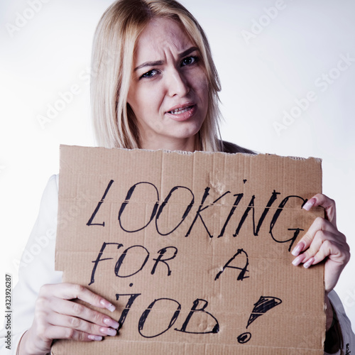 Depressed woman search a job and holding sign Looking for a job.
