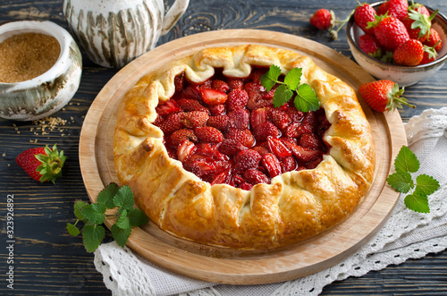 Fotografie Baked galette or open strawberry pie on the table.