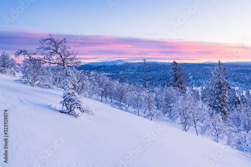 Norweigan mountain landscape at sunset with pink colors in sky.