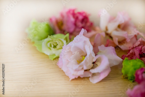 partially blurred background of wilted flowers in close-up on a wooden background © Nady