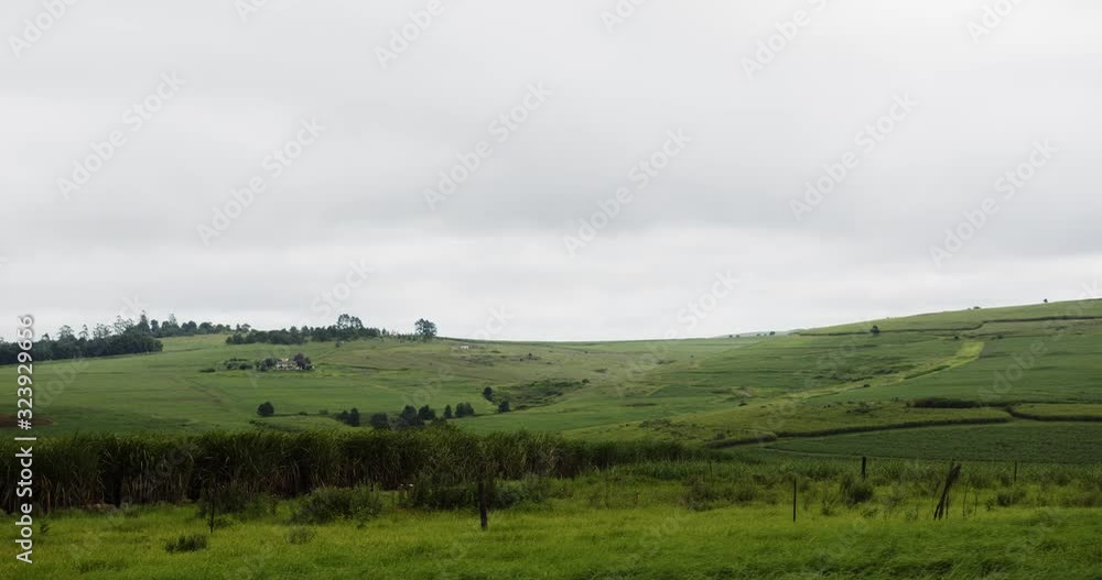 clouds fill the sky over beautiful green rolling hills clouds fill the sky over beautiful green rolling hills