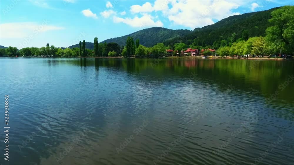 Mountain lake with turquoise water and green trees. Reflection in the water. Beautiful spring landscape with mountains, forest and lake. Aerial View. Drone shot over a beautiful mountain forest lake Mountain lake with turquoise water and green trees. Reflection in the water. Beautiful spring landscape with mountains, forest and lake. Aerial View. Drone shot over a beautiful mountain forest lake