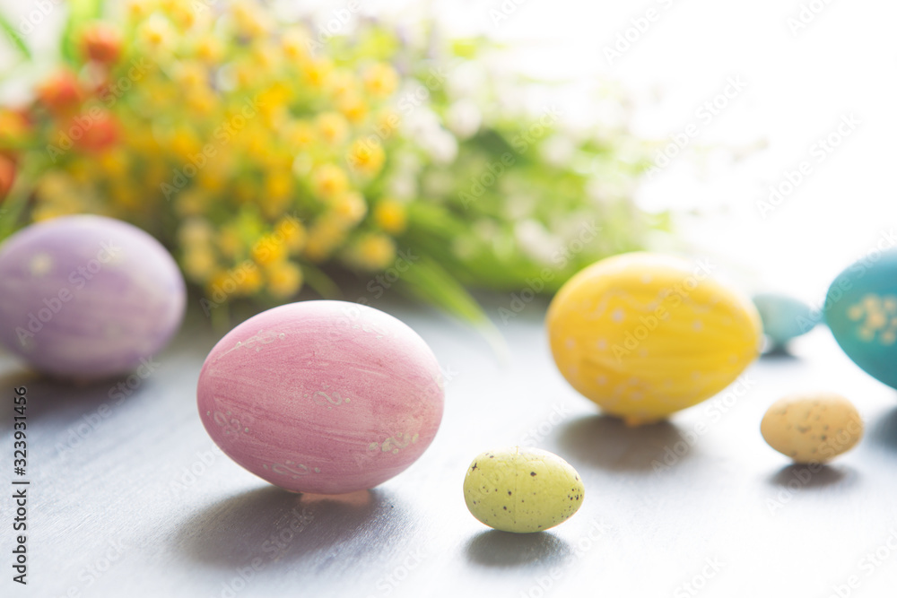 Easter eggs decoration with and flowers on a gray wooden table. Easter eggs decoration with and flowers on a gray wooden table.