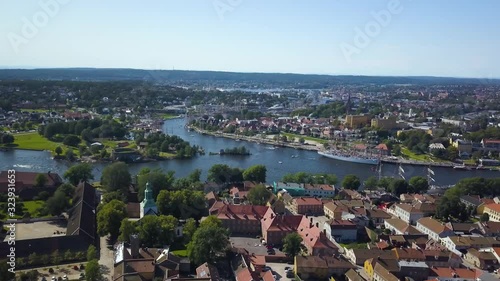 Aerial view of Tall Ship Race in Fredrikstad Norway from over fortress town with large ships in canal
