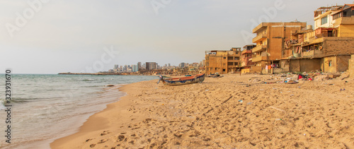 Fotografia Beirut, Lebanon - once a popular bathing spot, the Saint Simon beach today is a pretty messy district with rundown buildings and trash all over