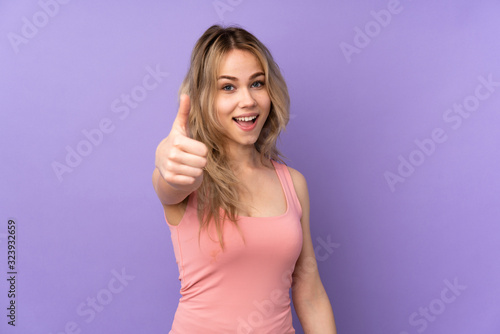 Teenager Russian girl isolated on purple background with thumbs up because something good has happened