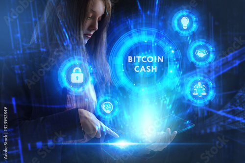 Business, Technology, Internet and network concept. Young businessman working on a virtual screen of the future and sees the inscription: Bitcoin cash