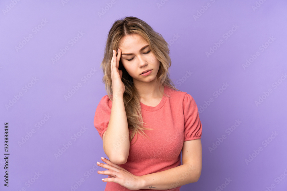 Teenager Russian girl isolated on purple background with headache Teenager Russian girl isolated on purple background with headache