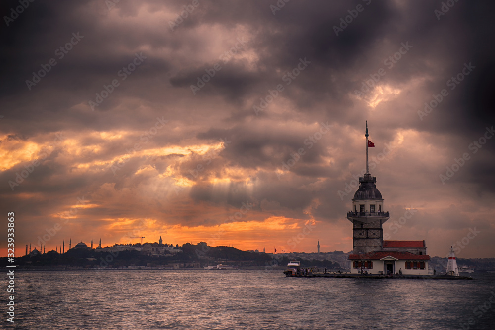 Maiden's Tower and Istanbul Landscape on a cloudy day with changing lights. Maiden's Tower or Kiz Kulesi located in the middle of Bosphorus, Istanbul in Turkey.