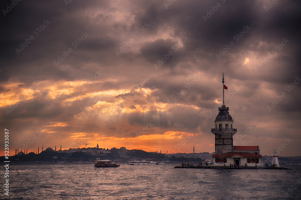 Maiden's Tower and Istanbul Landscape on a cloudy day with changing lights. Maiden's Tower or Kiz Kulesi located in the middle of Bosphorus, Istanbul in Turkey.