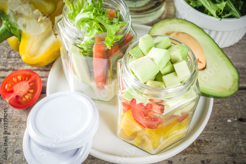 Healthy take-away lunch jar. Vegan vegetable salad in glass jars, with sliced fresh vegetables. Detox, raw eating and zero waste lunch concept