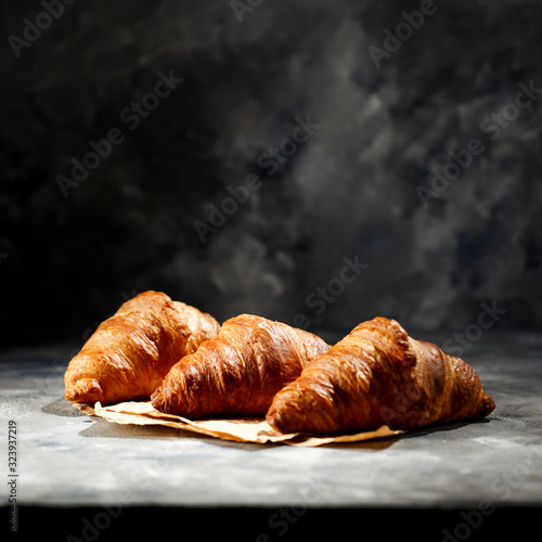Tablou canvas Fresh croissant on dark mood background and copy space for your product