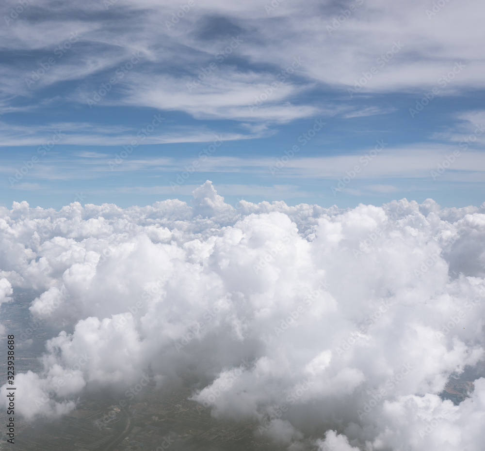 Photo from the window of an airplane. View from above on clouds and the earth. High. Sunny and cloudy day. Photo with telephone. View of the sky. Photo from the window of an airplane. View from above on clouds and the earth. High. Sunny and cloudy day. Photo with telephone. View of the sky.