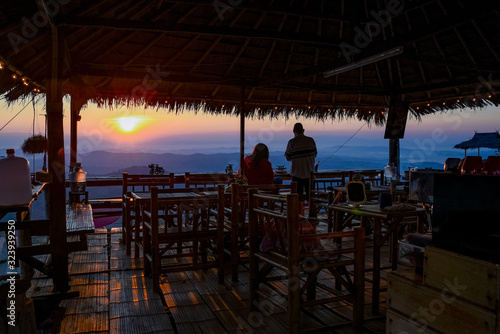 silhouette of man sitting in the mountain at sunset