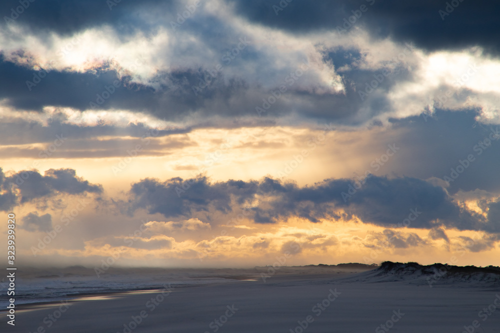 Grand Beach Sunset with Soft Sand and Large Clouds Grand Beach Sunset with Soft Sand and Large Clouds
