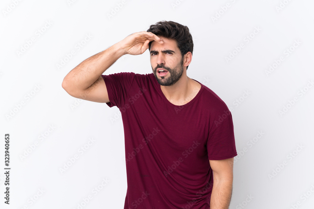 Young handsome man with beard over isolated white background looking far away with hand to look something Young handsome man with beard over isolated white background looking far away with hand to look something